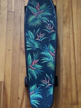Globe Black Skateboard Deck with Green Palm Leaves and Red Floral Accents